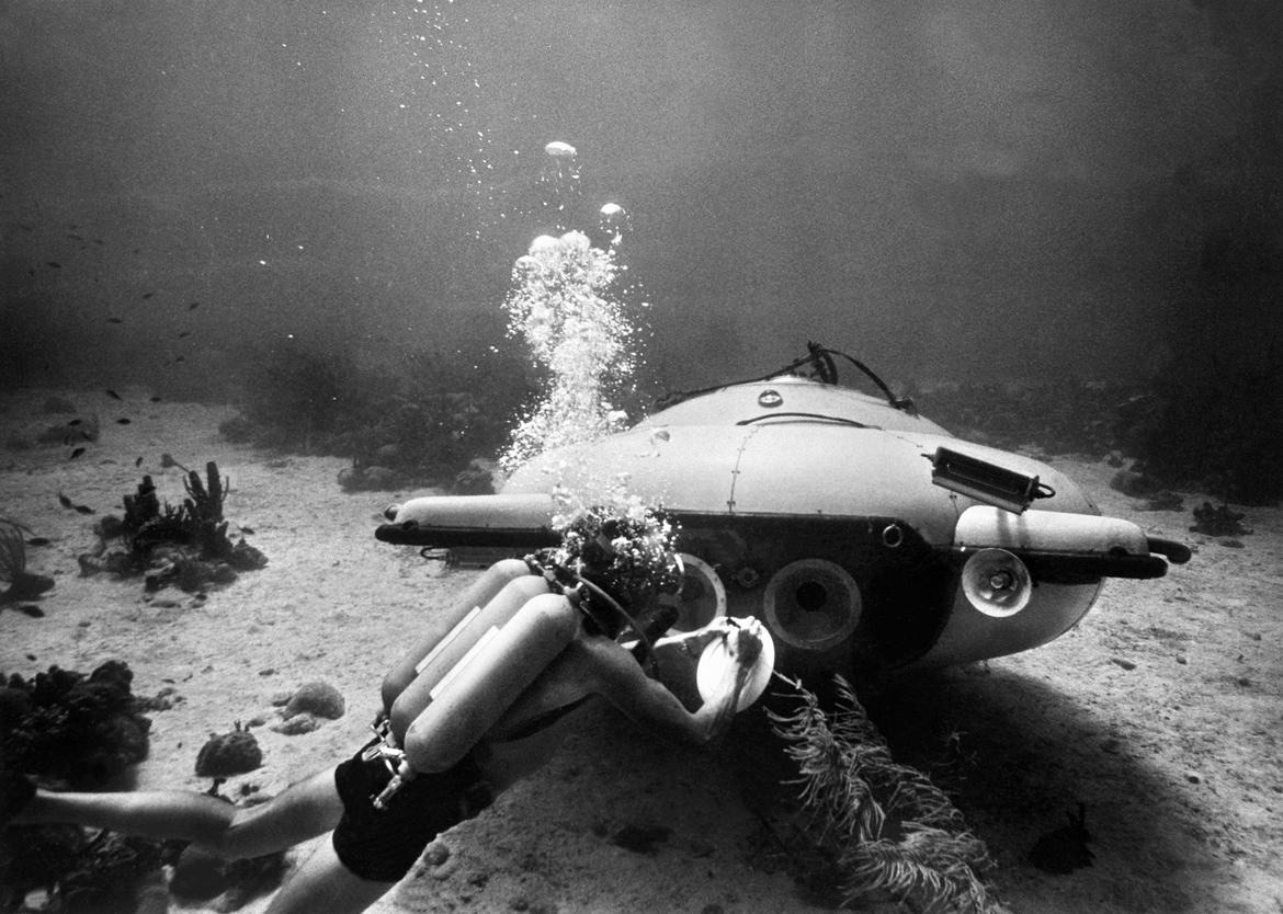 Picture taken in June 1963 of French explorer and oceanographer Jacques-Yves Cousteau near his "diving saucer" during an undersea exploration in the Red Sea. Together with Jean Mollard, he created the SP-350, a two-man submarine that could reach a depth of 350 m below the ocean's surface. (Photo credit should read OFF/AFP/Getty Images)