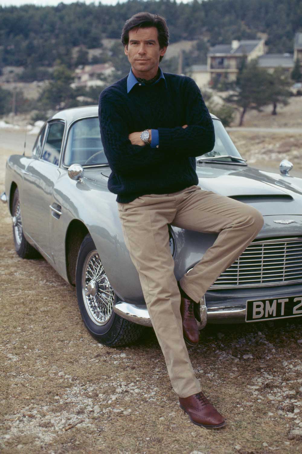 Classic elements of James Bond 007's equipment; the stunning Aston Martin DB5 and an OMEGA Seamaster Diver 300M on the wrist. Here, Pierce Brosnan during the shooting of Goldeneye, 1995.